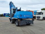 a blue crane that is parked in a parking lot