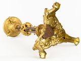 a gold plated object on a white background