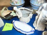 a blue table with a lot of vases and figurines on it