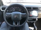 the interior of a car with a steering wheel and dashboard controls