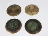 four different types of brass buttons sitting on top of a white surface