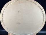 a white plate sitting on top of a wooden stand