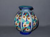 a blue vase with a design on it on a table