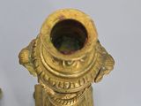 pair of antique brass candlesticks on stand on white background