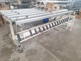 an image of a conveyor belt in a warehouse with boxes on it