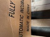 a cardboard box sitting on top of a pile of wood