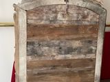 a picture of a bed with a wooden headboard and a red blanket