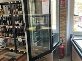 bottles of wine are on display in a store with tiled floors