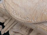a close up of a carved wooden clock on a table