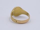 a close up of a gold ring on a white surface