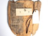 a piece of wood with a piece of paper attached to it