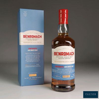the bottle of benromach is next to a box of whisky