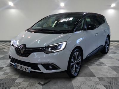 la voiture blanche est garée sur un sol en damier dans le garage