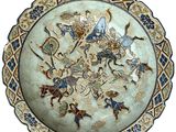 a blue and white plate with a picture of people on it