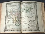 an open book with a map of europe and asia on it