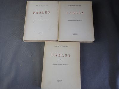 trois livres empilés les uns sur les autres, posés sur un lit