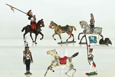 several figurines of toy soldiers on display on a white surface