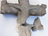 a cross made out of cement on a white surface