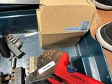 a box of tools sitting on a table next to a pair of shoes