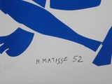 a blue and white sign with a picture of a fish on it