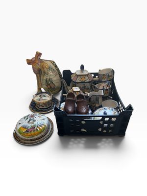 a black basket filled with assorted items on a white surface