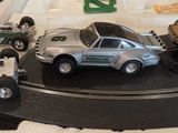 many toy cars that are on a track in a display