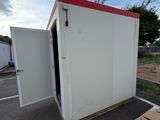 an image of a portable toilet in a parking lot