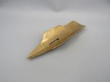 gold plated metal object on a white surface with a white background
