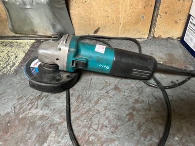 an image of a corded angle grinder on the floor