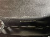 a black purse that is sitting on a table