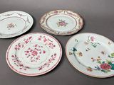 three plates with floral designs are sitting on a table