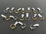 several different types of rings on a table with tags on them