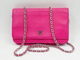 un sac à main rose avec une chaîne qui l'entoure et une autre chaîne qui l'entoure