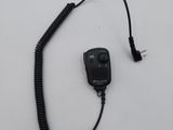 a close up of a cord connected to a radio on a white surface