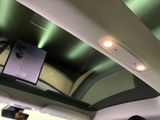 a man that is sitting in the back seat of a car