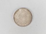 a close up of a coin on a white surface
