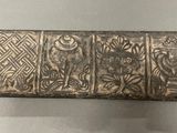 a close up of a metal object on display on a table