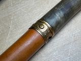 a wooden stick with a metal ring on it