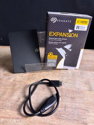 the external hard drive is sitting next to the box of the external hard drive