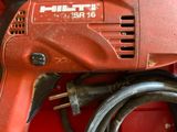 a red tool box with a drill and a cord in it