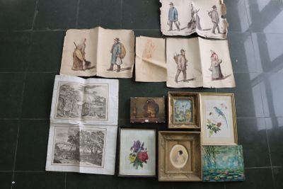 a lot of old books and pictures on the floor