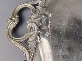 a silver plate with a handle on it
