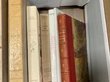 a lot of books in a box on the floor
