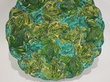 a green plate with a lot of green leaves on it