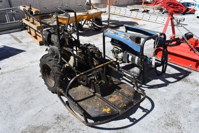 a tractor with a trailer attached to it in a parking lot