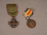 two medals and a medal sitting on a table