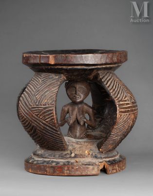 an old wooden table with a carved figure on top of it