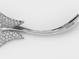 un gros plan d'une broche en forme de nœud ornée d'un diamant, sur fond blanc