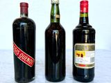 three bottles of wine sitting on a marble table