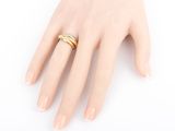 gold plated ring on a female ' s hand on a white background